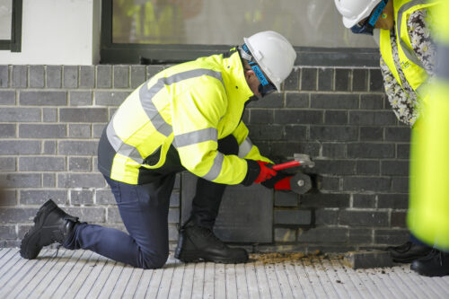 11 Jason Dawson Senior Responsible Officer Childrens Cancer Centre chiselling the bricks around the time capsule1