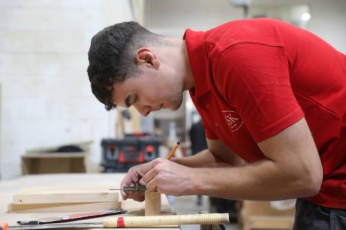 Three apprentices looking at plans
