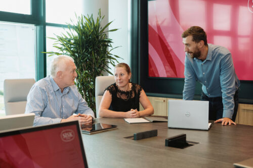 Staff at a desk talking