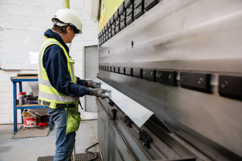 Sisk member of staff working with sheet metal